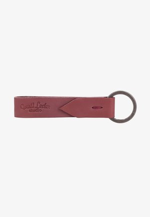 Brown leather keychain with a looped strap and metal key ring, embossed with "Gusti Leder studio" on the strap.