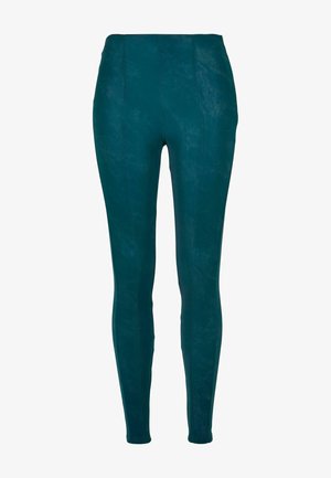 Tealfärgade leggings med en mjuk textur, som har hög midja och en figurnära design. De har vertikala sömmar för extra stil.