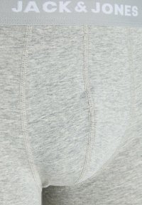 Grey boxer briefs with a soft texture, featuring a white elastic waistband and simple stitch detailing. Brand name is visible on the waistband.