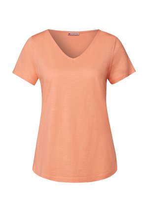 Persikofärgad V-ringad T-shirt i mjukt material, med korta ärmar och avslappnad passform. Slät yta med en enkel, ren design.