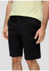 Black cotton shorts featuring a simple design, standard waistband with a button closure, and a smooth texture. No visible patterns or accents.