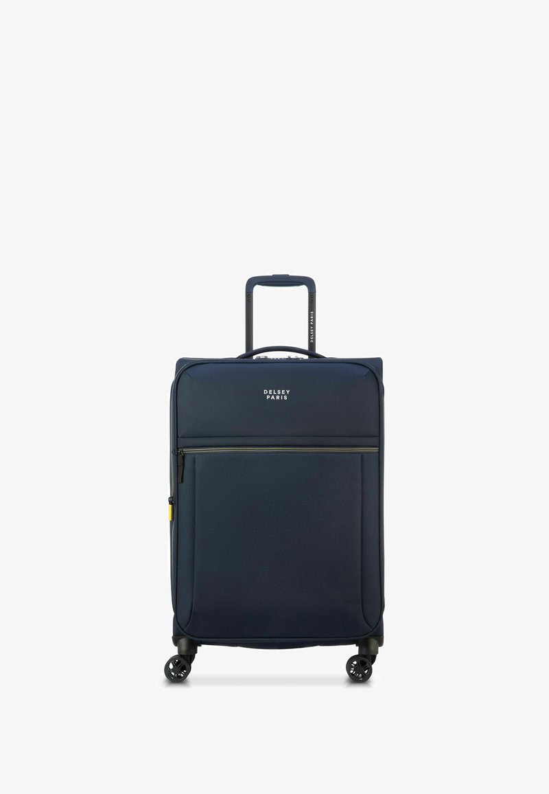 Donkerblauwe soft-shell koffer met een uitschuifbare handgreep, vier multidirectionele wielen, een ritszak aan de voorkant en het Delsey Paris-logo.