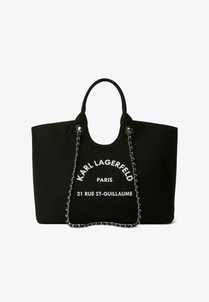 Zwarte Karl Lagerfeld tote tas met kettingriemen en witte tekst "Karl Lagerfeld Paris 21 Rue St-Guillaume" aan de voorkant.