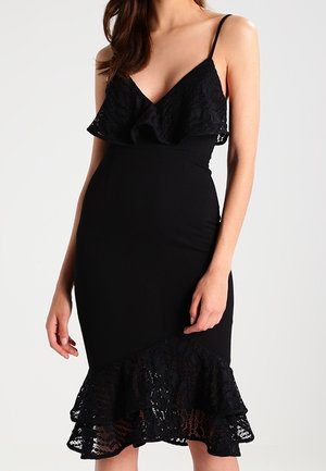 Zwarte jurk met een lijfje van kant met ruches en een wijde rand van kant. Slank model met dunne bandjes, gemaakt van een gladde, rekbare stof.