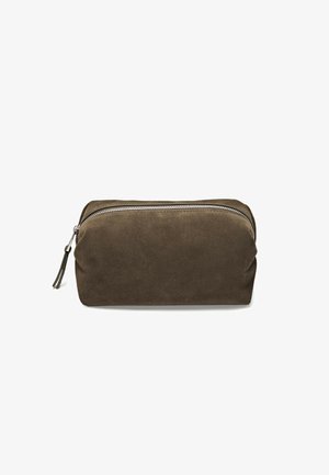 Brown suede cosmetic bag with a rounded shape, featuring a silver zipper and a leather pull tab. Smooth texture and simple design.