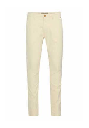 Beige bomull chinos med slim fit, med knappfeste og subtile stikkingdetaljer på lommene. Glatt tekstur med en polert finish.