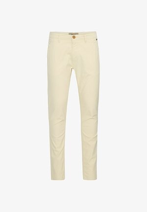 Bež pametne chinos hlače z oprijetim krojem, s klikom za zapiranje in subtilnimi šivi na žepih. Gladka tekstura s sijočim zaključkom.