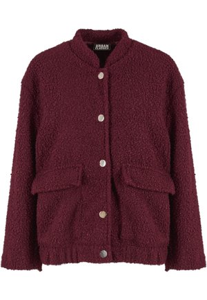 Bordo jakna u stilu mede s uspravnim ovratnikom, srebrnim kopčama na drukere i dva prednja džepa. Mekani, teksturirani materijal s elastičnim pojasom.