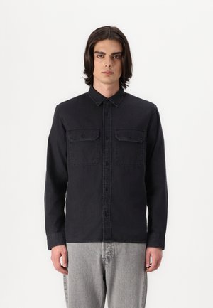 Dark denim shirt with a button-up front, collar, two chest pockets, long sleeves, and a slightly textured finish.