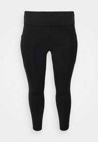 Leggings negros hechos de una tela elástica, con una cinturilla alta y recortes en los tobillos con pequeños acentos decorativos a lo largo de las costuras.