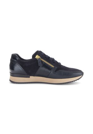Black leather and suede sneaker with beige sole, black laces, and gold side zipper viewed from the outer side.