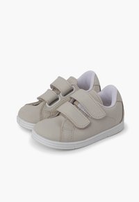 Scarpe sintetiche di un grigio chiaro con due strappi in Velcro, interno bianco e suola in gomma testurizzata con una punta arrotondata.