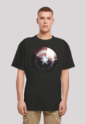 Black t-shirt featuring a circular graphic design with red, white, and blue tones, resembling a star and shield pattern. Cotton material.