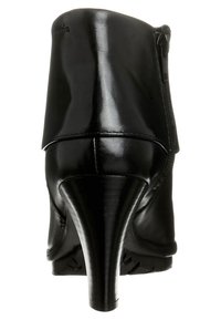 Botín negro con un acabado de cuero brillante y suave. Presenta una punta afilada, un alto tacón de aguja y un detalle de cremallera lateral.