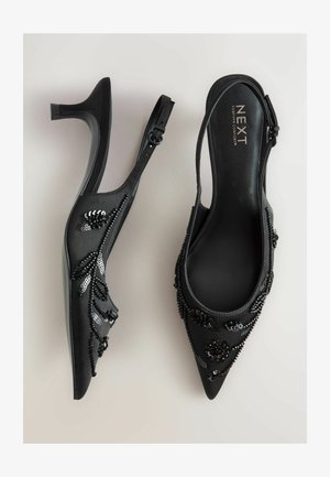 Mustad seljaosas kõrgendatud kontsad, terava varbaga, kaunistatud helme ja sequin lillemustritega, peene sünteetilise materjaliga ja saleda kannaga.