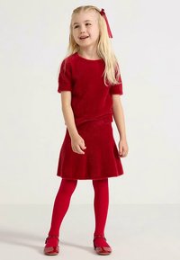 Red fuzzy knit top and matching flared skirt, paired with red tights and red shoes. Features short sleeves and a textured finish.