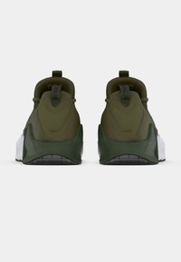 Green athletic shoes with a textured upper, padded collar, and white outsole. Includes a pull tab at the back for easy wear.