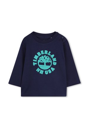 Merihenkinen pitkähihaista paitaa puuvillasta, jossa on pyöreä pääntie. Ominaisuuksiin kuuluu turkoosi painettu Timberland-logo pyöreässä muotoilussa ja olkanapeilla.