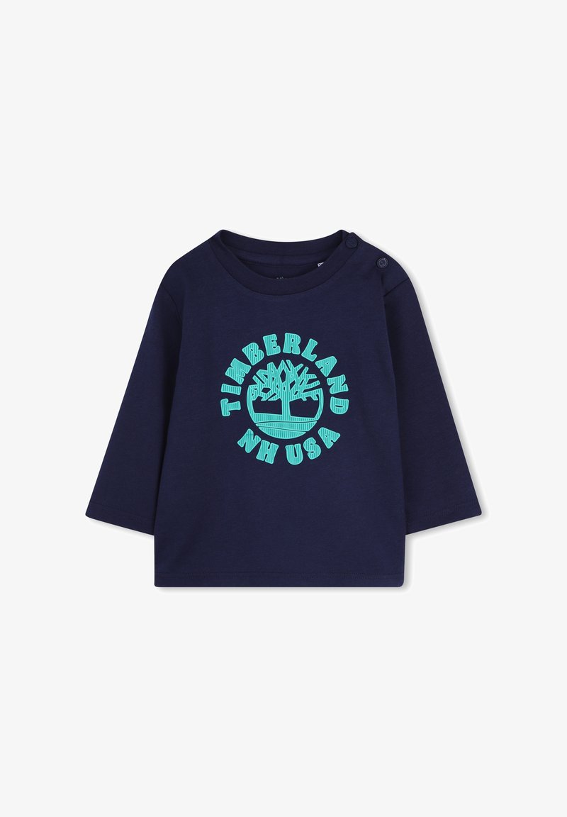 Marintröja med lång ärm i bomull och rund halsringning. Har en turkos tryckt Timberland-logotyp i cirkelform och tryckknappar på axlarna.