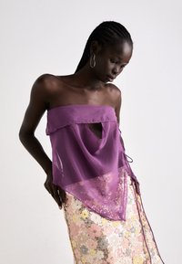 Purple sheer top with a keyhole cutout, paired with a multi-colored floral sequin skirt featuring a gradient of pink, yellow, and gold.