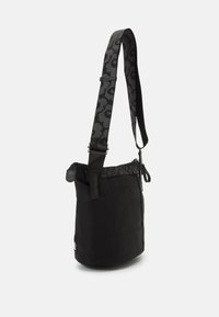 Black shoulder bag with a textured grey strap featuring a pattern. Main compartment has a zipper and a side pocket. Simple design.