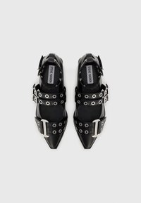 Black leather pointed-toe shoes with silver hardware, featuring multiple straps with grommets and an adjustable ankle buckle.