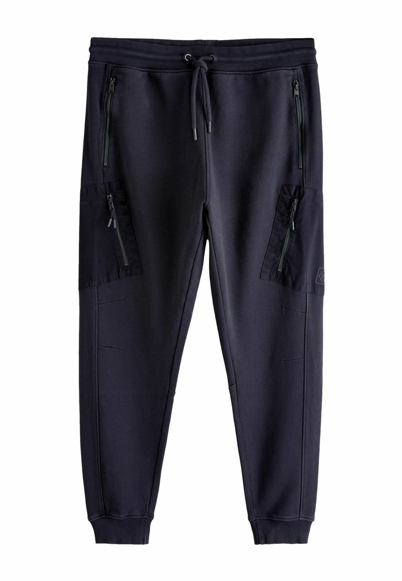 Tumesinised dressipüksid, millel on nööriga vöökoht, kaks lukuga küljetaskut ja kitsenev lõige. Valmistatud siledast, tekstuuriga kangast.