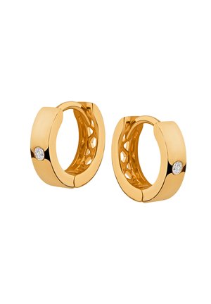 Złocone kolczyki w kształcie hoop z gładkim wykończeniem, diamentowym akcentem i ażurowym wzorem po wewnętrznej stronie. Średnica jest średnia.