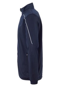 Giacca a zip blu navy con colletto alto, piping laterale bianco e tasche laterali con zip. Realizzata in un tessuto liscio e elasticizzato.