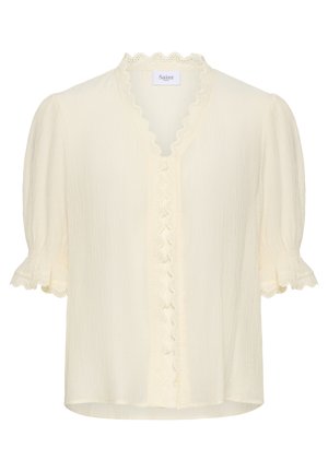 Bluză crem cu mâneci scurte bufante, tiv din dantelă cu margine ondulată de-a lungul decolteului în formă de V și a plăcii frontale cu nasturi, și manșete cu volane.