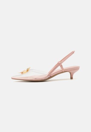 Pink slingback heels with a pointed toe, transparent upper, and a floral embellishment. Features a low heel and smooth texture.