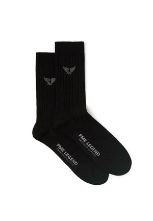 Paire de chaussettes noires côtelées avec le logo PME Legend sur les bords côtes et le texte PME Legend American Classic sur les semelles.