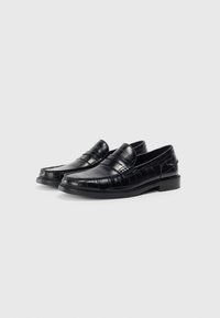 Loafers negri cu un model texturat de crocodil, din piele netedă, cu toc mic și un design tradițional de tip slip-on.