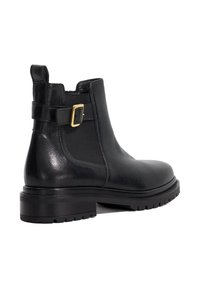 Black leather ankle boot with a rounded toe, textured finish, decorative buckle on the ankle strap, and a sturdy, grooved rubber sole.