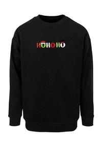 Black sweatshirt featuring "Ho Ho Ho" in multicolored letters, adorned with festive icons: a Santa hat, reindeer antlers, and a top hat.