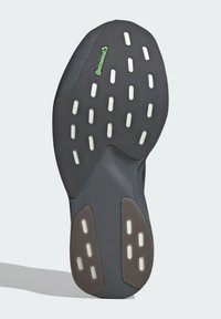 Czarna gumowa podeszwa z teksturowaną powierzchnią. Posiada białe rowki oraz wyściełane obszary w ciemnym brązie. Zawiera zielone logo Continental.