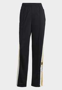 Svarta träningsoch med vita och guld sidostripes, elastisk midja och Adidas-logga på vänster ben.