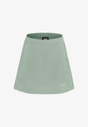 Jupe sportive vert clair avec taille élastique, poches latérales et logo Jack Wolfskin près de l'ourlet.