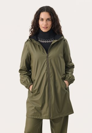 Olive green waterproof jacket with a front zipper, elastic cuffs, and a hood. Textured knit turtleneck underneath features a patterned accent.