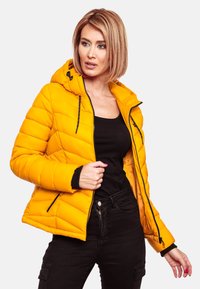 Yellow puffer jacket with a hood, featuring black accents, a zippered front, and visible stitching. Textured, padded design with elastic cuffs.
