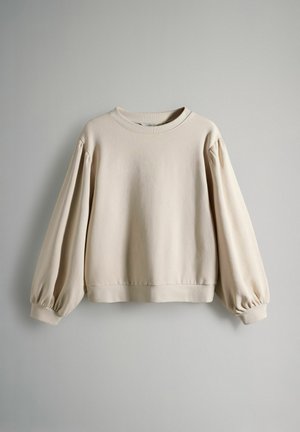 Beiger Sweatshirt mit rundem Ausschnitt, überschnittenen Schultern und voluminösen langen Ärmeln. Weicher, strukturiert Stoff mit einem verkürzten Saum.