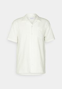 Camicetta a maniche corte con colletto in off-white con un motivo a trama testurizzata simile al waffle. Presenta una tasca e bottoni sul davanti.