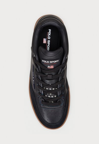 Black leather sneaker with rubber sole, featuring lace-up closure, perforated toe box, and "Polo Sport" branding on tongue and insole.