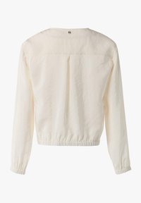 Biała, krótka bluzka z długim rękawem, o okrągłym dekolcie, z elastycznym dołem i mankietami, z pojedynczym guzikiem z tyłu przy szyi.