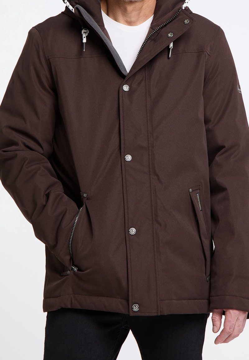 Brown waterproof jacket with a hood, zippered front, side pockets, and silver hardware accents. Features a soft lining for added warmth.