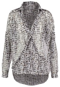 Blouse manches longues à col en V avec motif abstrait de carrés gris et beige, poches avant, coupe ample et fluide.