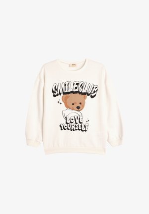 Crème-kleurige sweatshirt met een berenafbeelding en de tekst "SMILECLUB" en "LOVE YOURSELF." Met boorden aan de mouwen en een ronde halslijn.
