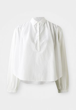 Camicia bianca a maniche lunghe con colletto, chiusura a bottoni e dettagli arricciati sulle spalle. Tessuto liscio e vestibilità ampia.