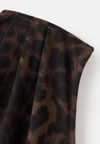 Brown and black leopard print fabric with a smooth texture, featuring pleats and a hemmed edge. The material appears lightweight and flowing.
