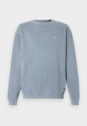 Lyseblå sweatshirt laget av bomull, med en ribbestrikket rund hals, lange ermer og en liten logo på brystet. Myk, teksturert finish.